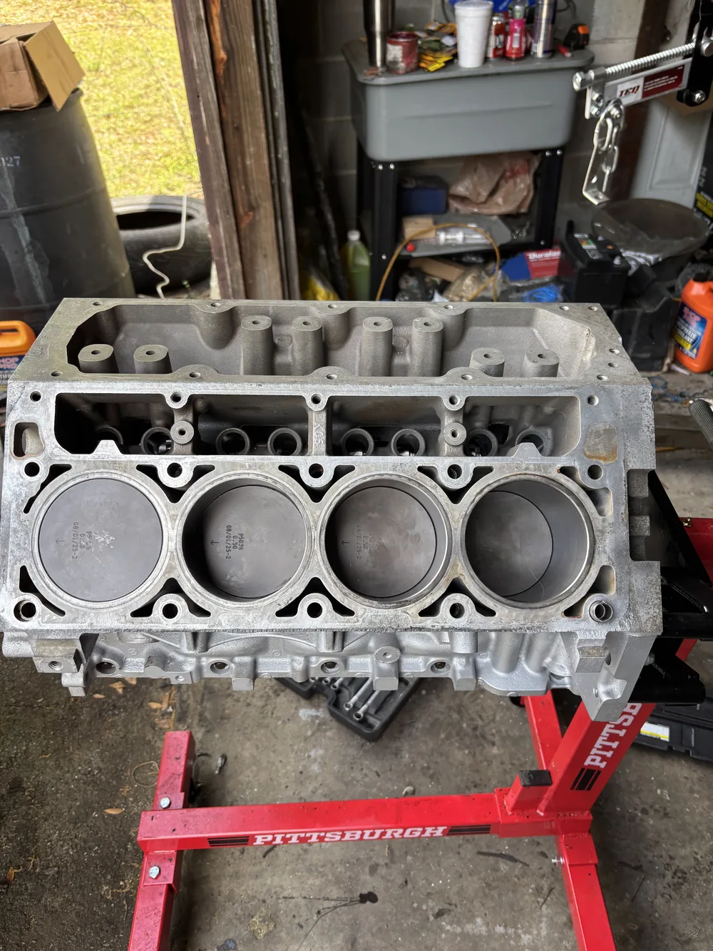 An engine block mounted on a stand mid-rebuild